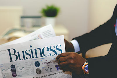 Businessman reading a financial business newspaper