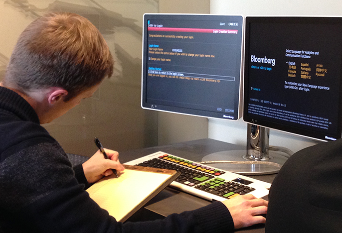 Student in the Bloomberg Finance Lab making notes