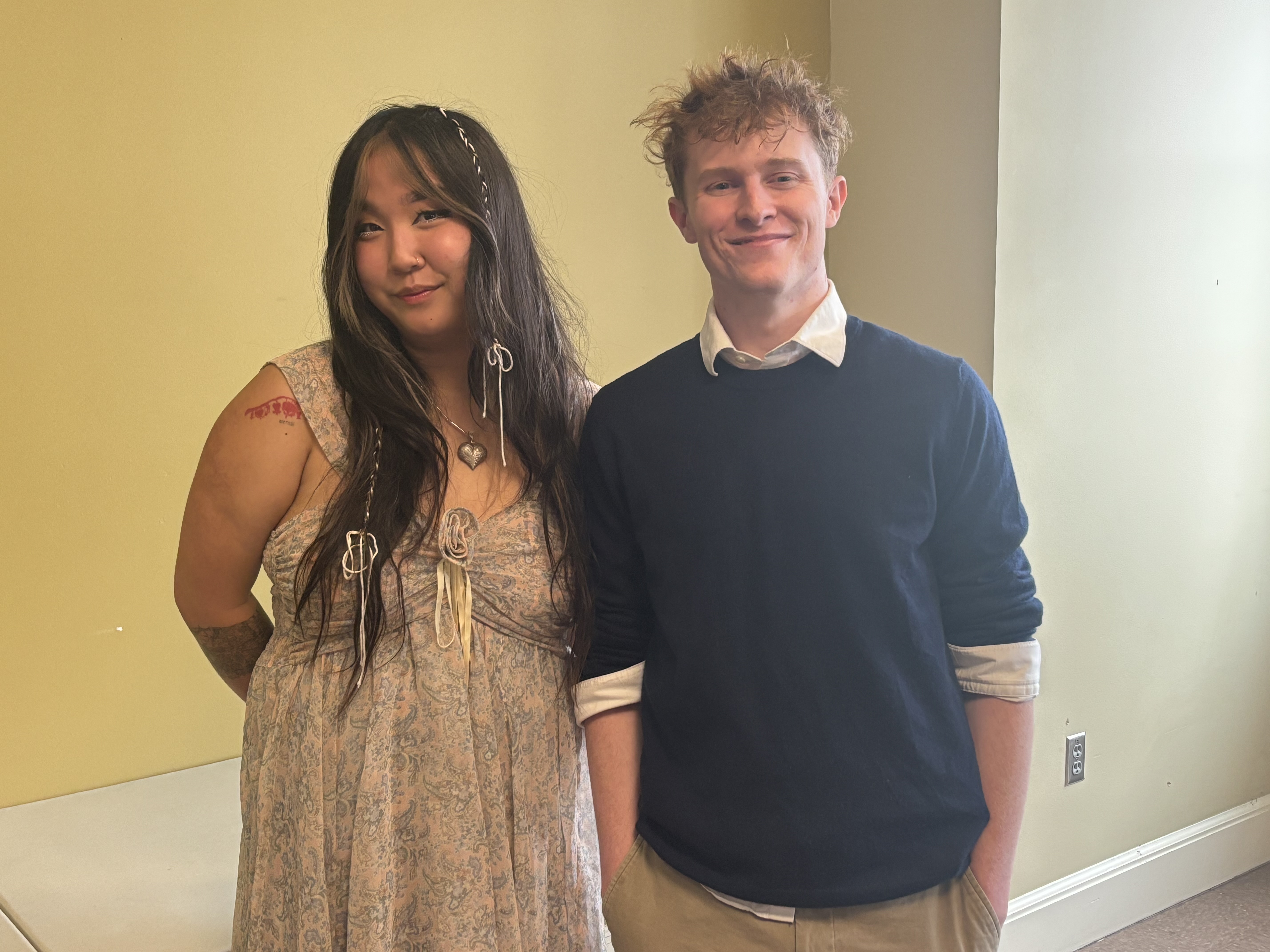 Two students smile and laugh