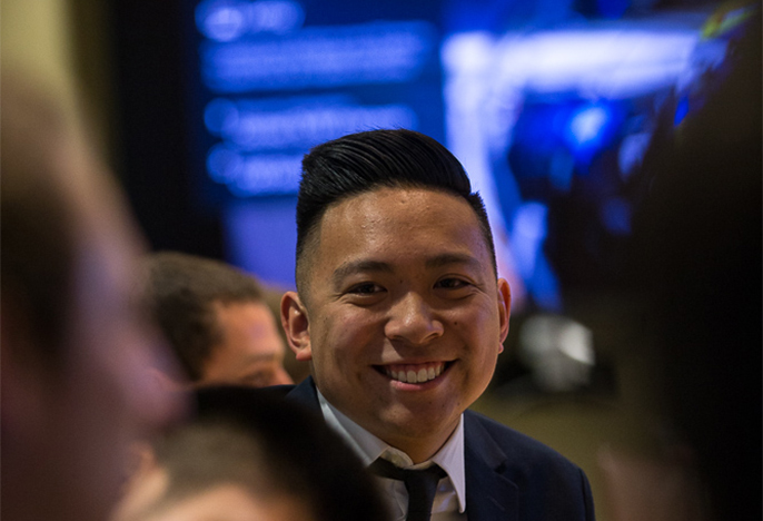 Male student in suit smiling at camera