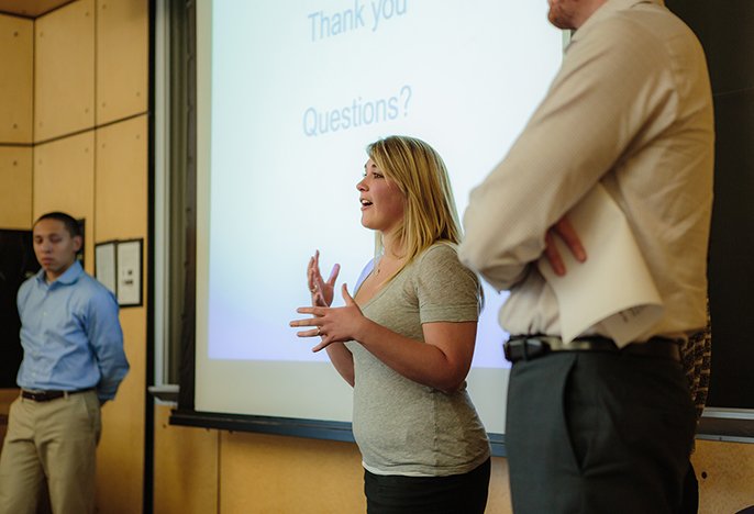 Business presenting her project to her class