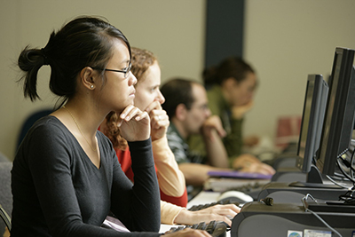 Students working in front of computer terminals.